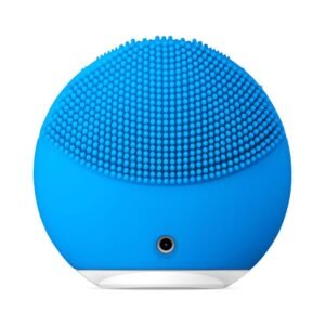 Blue silicone facial cleansing brush with densely packed soft bristles and a curved base.