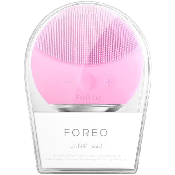 Foreo Luna mini 2 facial cleansing device in pink with silicone bristles and control buttons on the front side, displayed in its clear case. Brand: Foreo. Model: Luna mini 2.