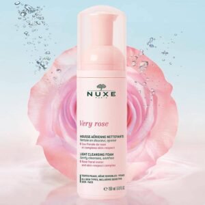 Pink Nuxe Very Rose cleansing foam bottle with a pink rose in the background
