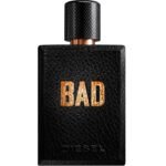 Close-up of a black textured perfume bottle with a copper neck and copper 'BAD' lettering on the front.