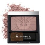 Pink powder blush palette in a black case with a small brush, Rimmel London branding visible. Powder spills around the left side.