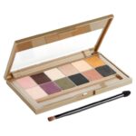 Open gold eyeshadow palette with 12 shades (neutrals and shimmers) and a dual-ended applicator brush nearby.