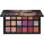 Open Huda Beauty Desert Dusk palette showing 18 color pans in neutral to metallic tones.1)