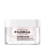 Cosmetic jar with a pale pink label reading FILORGA OXYGEN-GLOW, Paris, Crème super‑perfectrice éclat (super‑perfecting radiance cream).